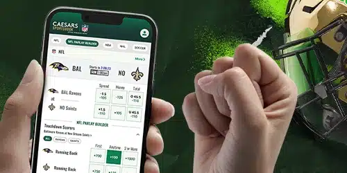 Caesars sportsbook registration banner with a hand holding a phone with the Caesars mobile app, another hand fist pumping, and a helmet